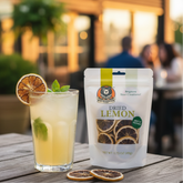 Dried lemon package with a cocktail on a wooden table outdoors.