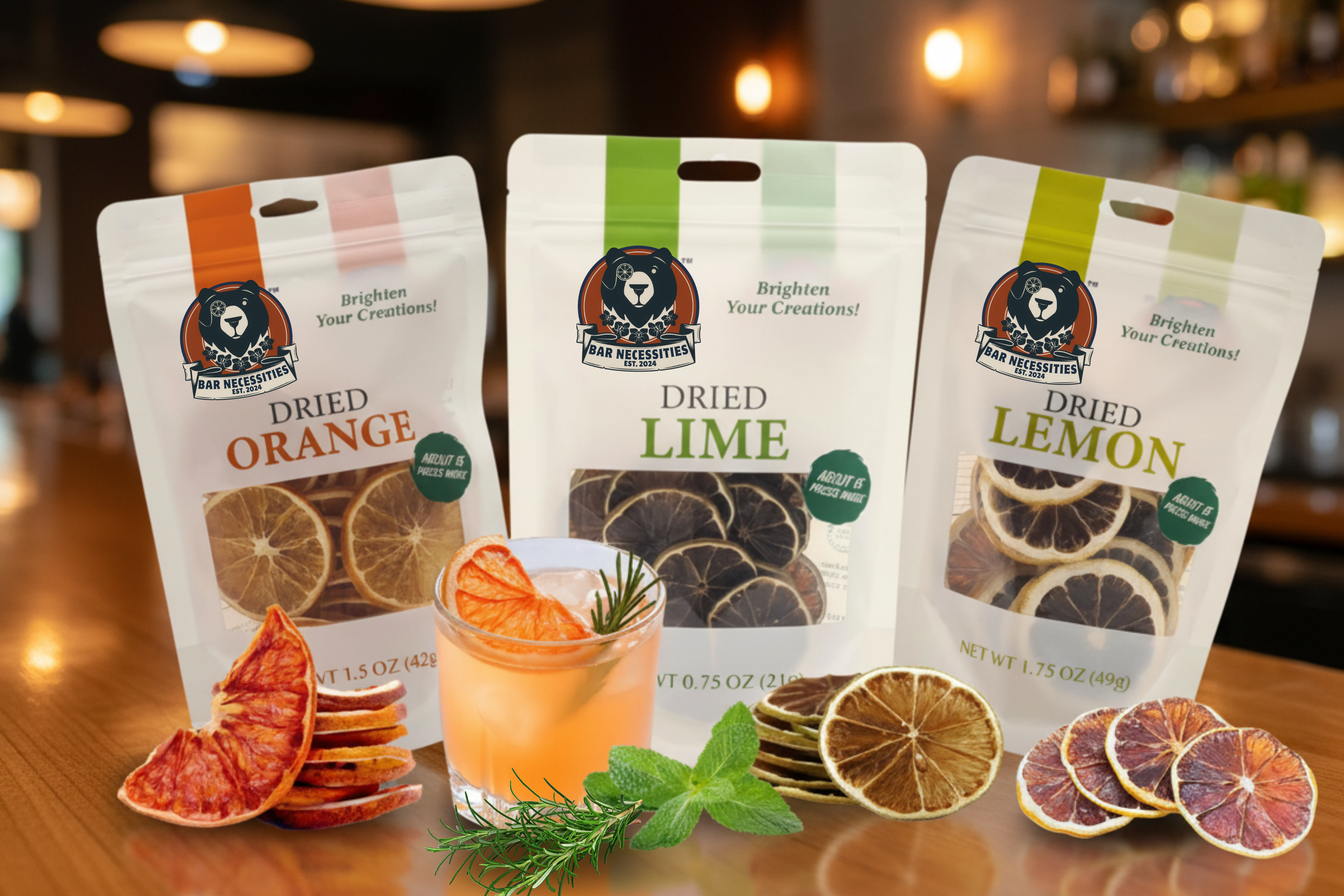 Three packages of dried citrus fruits with a glass of orange juice on a wooden surface.