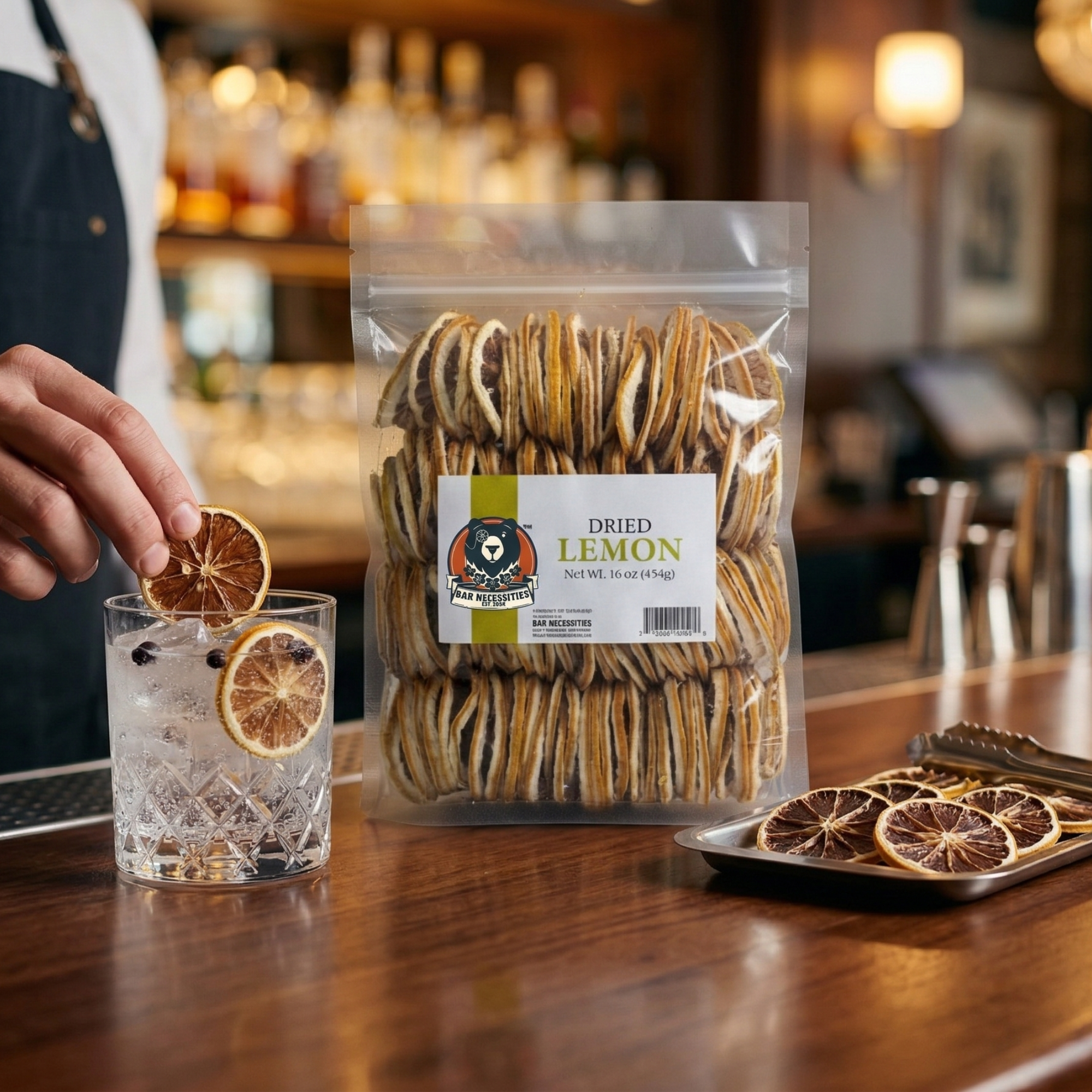 Dried lemon slices in a package on a bar counter with a glass of a drink.