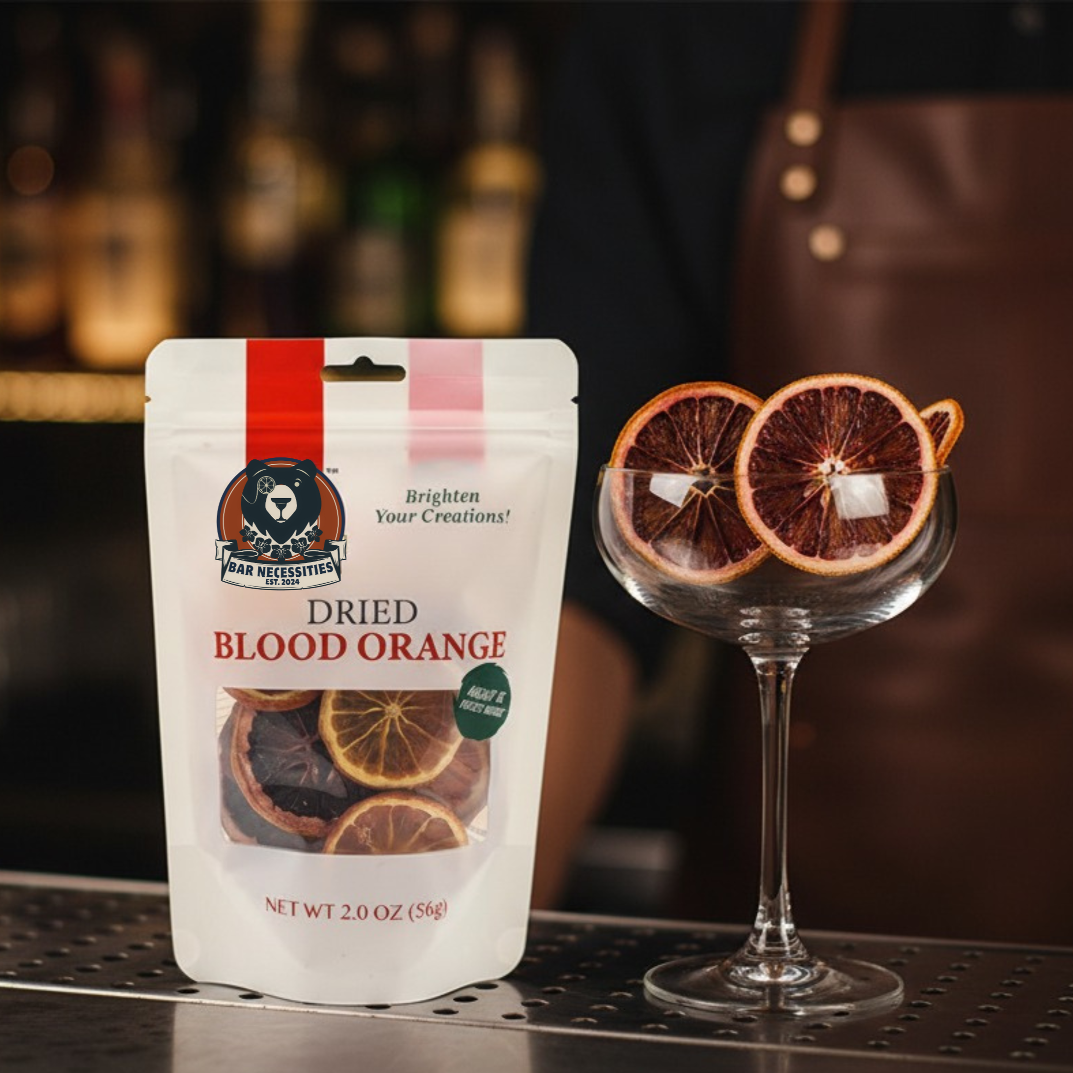 Packaged dried blood oranges on a bar with a cocktail glass.