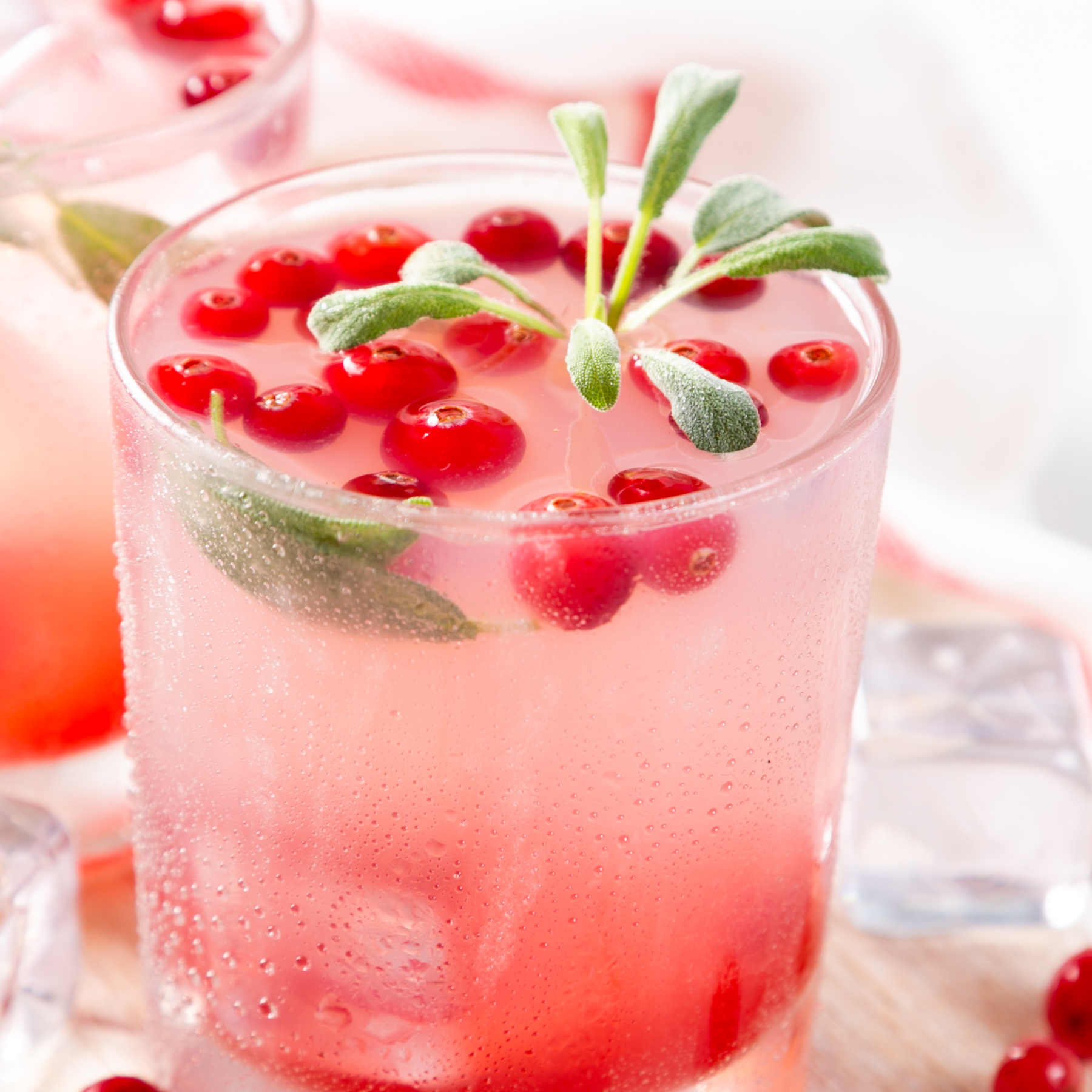Gourmet cocktail garnish featuring freshly picked sage leaves