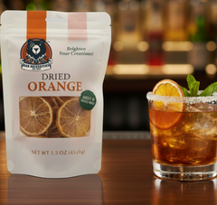 Dried orange package from Bar Necessities with a cocktail in the background Bar Necessities