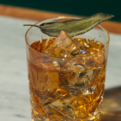 Gourmet cocktail garnish featuring freshly picked sage leaves