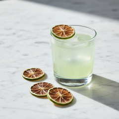 Glass of lemonade with lemon slices on a marble surface