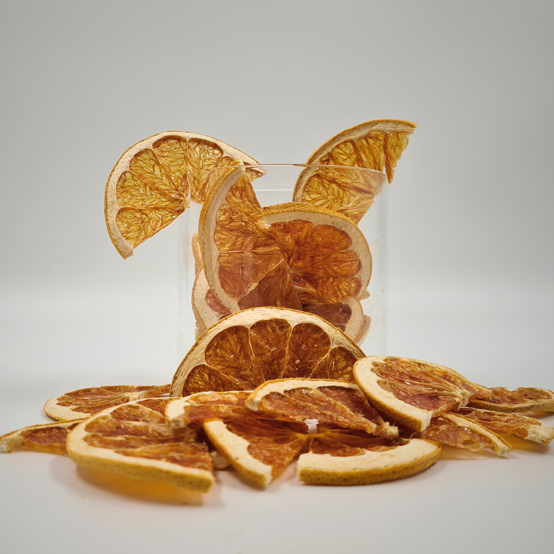 Dried citrus fruit slices with vibrant pink color for modern plating